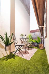 a room with a table and chairs and green grass at Elisabeth Residence - Home of the Gourmets in Sopron