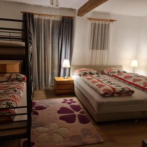 a bedroom with two bunk beds and a rug at Gasthof Barlida in Lainach