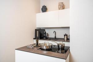 A kitchen or kitchenette at Loggiato Verga Luxury by Bed&Bros