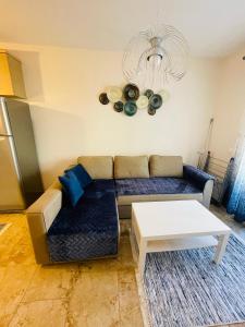 a living room with a couch and a table at DARIVA apartment Nea Skioni in Nea Skioni