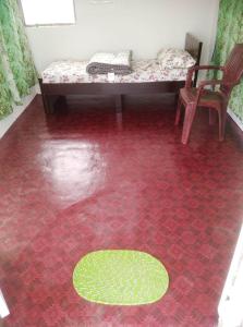 a room with a red floor with a table and a chair at Hi Bengaluru in Bangalore