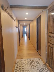 a hallway of a house with wooden floors and doors at Chambre Les étoiles de Bevy in Molunes