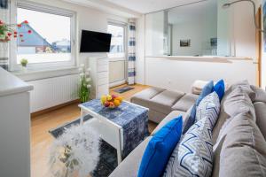 a living room with a couch and a table at Fewo Puuster in Norderney