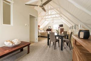 a dining room and living room with a table and chairs at 12 On Tindall in McGregor
