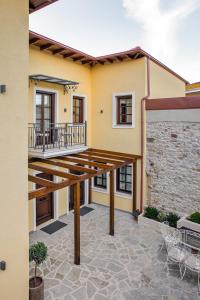 a patio of a house with a wooden deck at Petrou Suites in Ioannina
