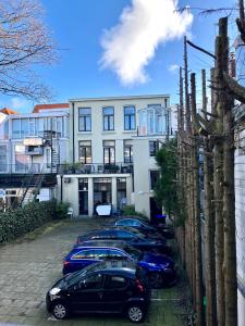 uma fila de carros estacionados em frente a um edifício em Het 33 The Hague center - Museum quarter em Haia