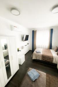 a bedroom with a bed and a tv and a mirror at Tau Design Hotel in Erlangen