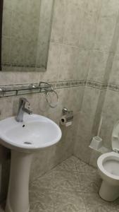 a bathroom with a sink and a toilet at Kipepeo Sky View in Nairobi