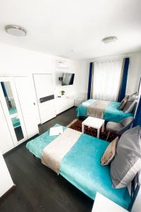 ein Hotelzimmer mit 2 Betten und einem Sofa in der Unterkunft Tau Design Hotel in Erlangen