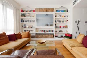 a living room with two couches and a tv at Brera Apartments in Garibaldi in Milan