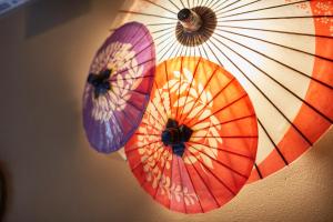 three colorful umbrellas hanging from a ceiling at Yukinohana in Yuzawa