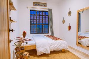 Postel nebo postele na pokoji v ubytování Cozy Stays Kigali