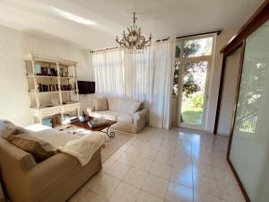 a living room with a couch and a chandelier at Gogas Amalfi Coast in Cetara