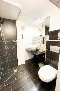 a bathroom with a toilet and a sink at Tau Design Hotel in Erlangen