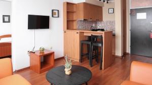 a living room with a table and a kitchen at Hotel Srbija-FREE PARKING in Belgrade