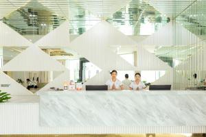 a group of people sitting at a counter in an office at S Vangvieng Boutique Hotel in Vang Vieng +96 photos