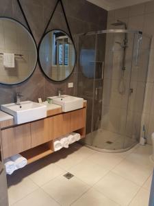 a bathroom with two sinks and a shower at Athena Studio Units in Roma