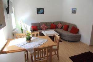 a living room with a table and a couch at Samonigghof in Latschach ober dem Faakersee
