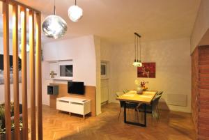 a living room with a table and a dining room at Heritage Apartment at Berindey French Villa, City Center, Bucharest in Bucharest
