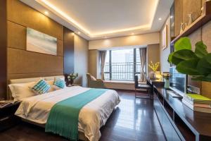 a bedroom with a large bed and a large window at Livetour Hotel Kehui Golden Valley Guanzhou in Guangzhou