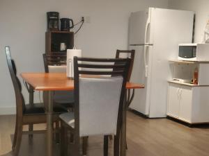 a kitchen with a table and chairs and a refrigerator at Beautiful Room 4mins from Gatineau-Ottawa Airport in Gatineau