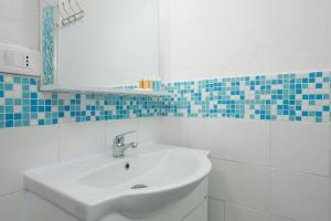 a bathroom with a sink and a mirror at Casa Salina Bamba in San Teodoro +14 photos