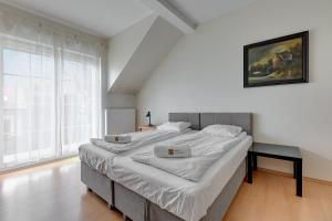 a large bed in a room with a large window at Villa Walecznych in Zaspa