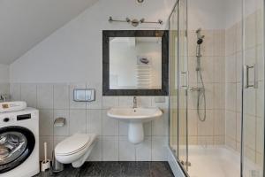 a bathroom with a sink and a toilet and a shower at Villa Walecznych in Zaspa