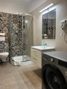 a bathroom with a shower and a washing machine at Urban Accommodation - Palas Mall Iasi in Iaşi +160 photos
