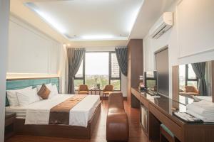 a hotel room with a bed and a desk at Royal Hotel & Apartment in Hanoi