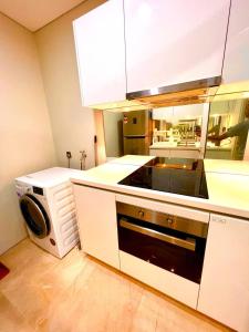 a kitchen with a stove and a microwave at Vortex suites near by KLCC in Kuala Lumpur