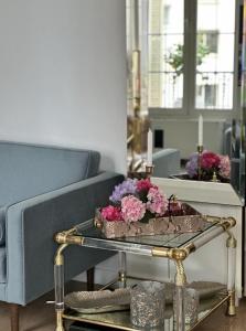 a living room with a table with flowers on it at Luxury Tenao palace, Monaco border, sea view in Beausoleil +24 photos