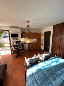 a living room with a bed and a kitchen at La Masa in Éze