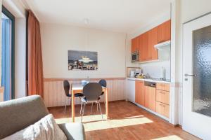 a kitchen with a table and chairs in a room at Appartement Greenlön in Westerland (Sylt)