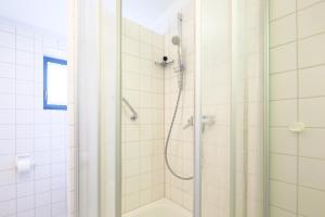 a bathroom with a shower with a glass door at Appartement Greenlön in Westerland (Sylt) +13 photos