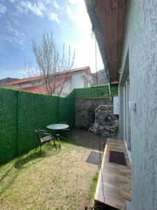 a patio with a table and a bench next to a fence at House in Mtskheta in Mtskheta