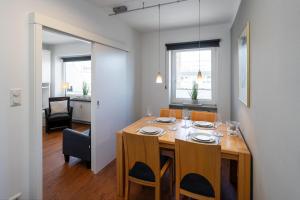 a dining room with a wooden table and chairs at Strandgeflüster in Westerland (Sylt) +13 photos