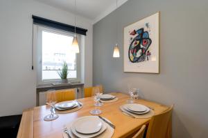 a dining room table with plates and wine glasses at Strandgeflüster in Westerland (Sylt)