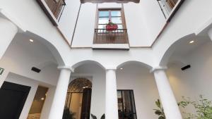 a building with a balcony and a window at Madeinterranea Suites in Málaga