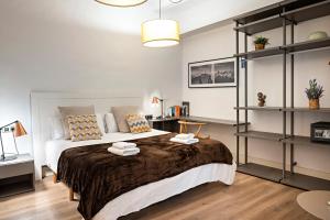 a bedroom with a large bed and shelves at Habitat Apartments Born in Barcelona