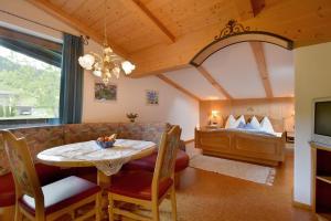 - un salon avec une table et un canapé dans l'établissement Alpenresidenz Unterrainer, à Ellmau