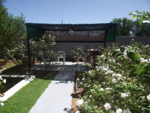 a garden with a pergola and some flowers at Lavender Rose in Bethulie