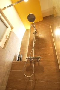 a shower in a stair room with a yellow ceiling at NEW Apartment in Berindey Villa - Historical Center, Universitate in Bucharest