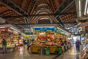 a market with people walking around in a building at Habitat Apartments Born in Barcelona