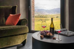 a room with a table with a bottle of wine and wine glasses at Dimora Cottanera in Castiglione di Sicilia