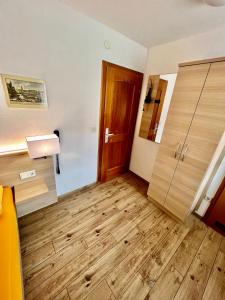 a room with a wooden floor and a door at Hotel-Heilsberg in Gottmadingen