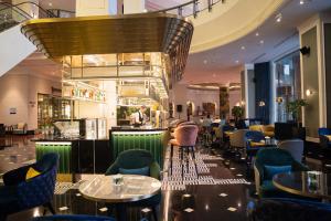 a restaurant with tables and chairs and a ceiling at Melia Hanoi in Hanoi