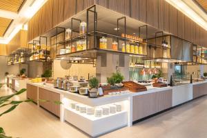 a restaurant with a counter with food on it at Melia Hanoi in Hanoi