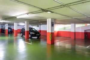 a parking garage with a car parked in it at Rooms & Suites Loft 2G Deluxe Edition Arrecife in Arrecife