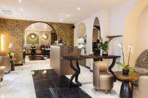 a lobby of a salon with a table and chairs at Hotel Khla Nice in Nice